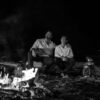 Two couples enjoying a camp fire on an African safari